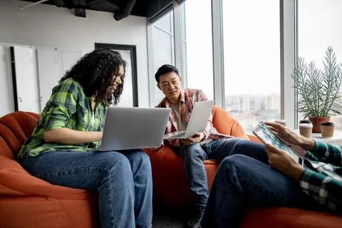 Fellow workers looking at computer screen in office interior Stock Photos