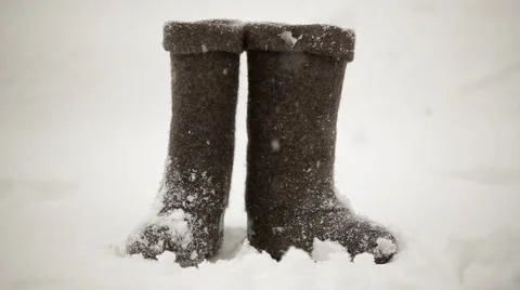 Felt boots in the snow Stock Footage 58122865
