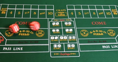Felt craps table with red oversize rolling dice. Stock Footage 100690176