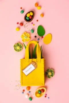 Felt Easter decorations and sweets on pink background Stock Photos