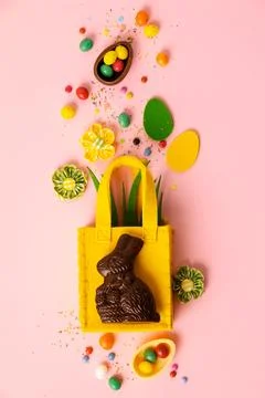 Felt Easter decorations and sweets on pink background Stock Photos
