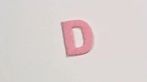 Felt letter “D” on white background. Defocus Stock Footage 60250496