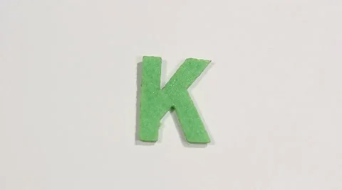 Felt letter “K” on white background. Defocus 動画素材 60251104