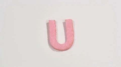 Felt letter “U” on white background. Defocus 動画素材 60252008