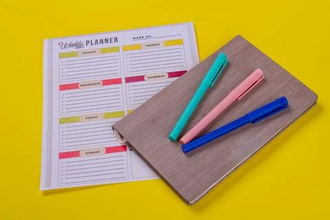 Felt-pens on the book and week calendar. Stock Photos