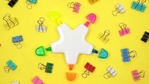Felt-tip pen in shape of star and stationery clips lie on rotating background. Video stock 204827389