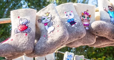 Felted boots of different design. Russian national winter felt footwear Stock Footage 303258265