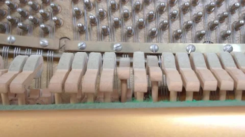 Felted mallets strike strings to produce sound or music when a person plays the 스톡 동영상 155363825