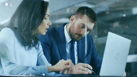 Female Accountant and Male Businessman Sitting at the Desk Having Discussion. Stock Footage