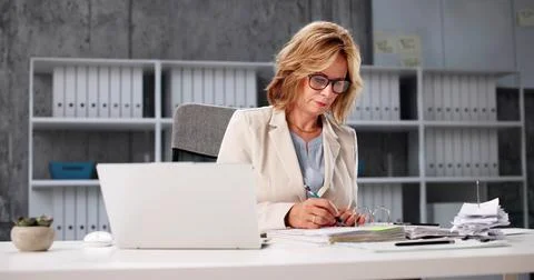 Female Accountant Using Cloud Software For Public Tax Invoice Advising. Elder Stock Photos