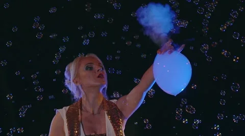 Female actor inflates bubbles with grey smoke and plays with them. Stock-Footage 67585591
