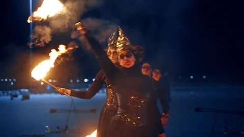 Female actors perform fire show wearing witch costumes. Stock Footage 257275880