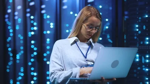 Female administrator using laptop computer running diagnostics of operative Stock Footage 118450519