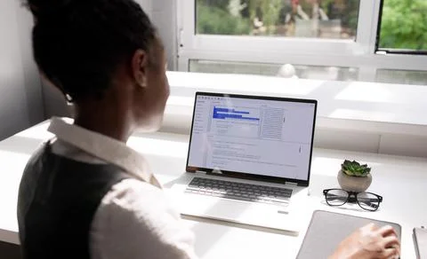 Female African American Programmer Developing Software On Laptop In Office Stockfoto's