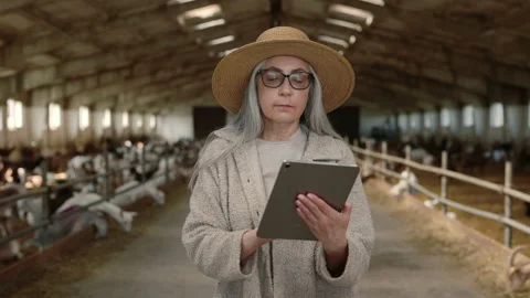 Female agronomist using digital tablet at goat farm Stock Footage 157586643