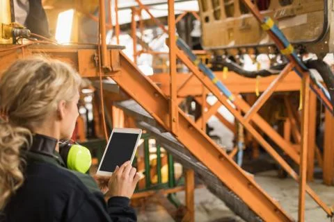Female aircraft maintenance engineer using digital tablet Stock Photos