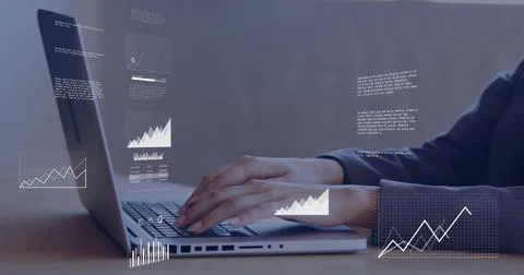 Female analyst typing code on laptop and reading charts at wooden desk, with Stock Photos
