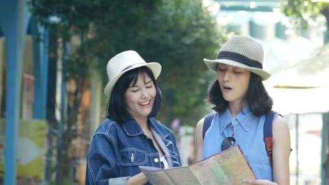 Female and friend using map to find some place while travel together. Stock Footage 97969762