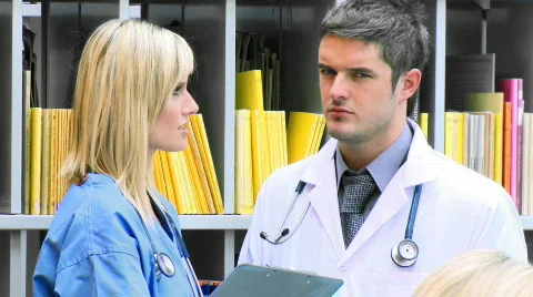 Female and male doctors talking in hospital footage Stock Footage