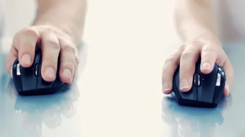 Female and male hand using a wireless computer mouse on reflective table Stock Footage