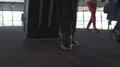 Female and male legs walking on carpeted airport floor with suitcase, departure HD Footage