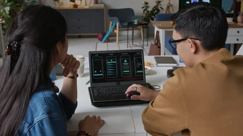 Female and Male Programmers Developing New Smartphone App Stock Footage 317340620