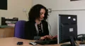 Female answers mobile at work, uneventful HD Footage