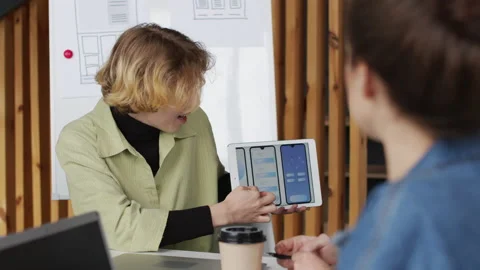 Female App Developer Showing Interface Ideas to Colleagues Video stock 144977985