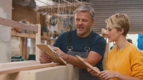 Female Apprentice Learning Skills From Mature Male Carpenter In Furniture Stock Footage 242228650