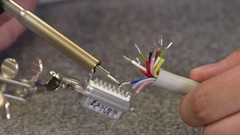 Female apprentice soldering together electronic components Video stock 237316135