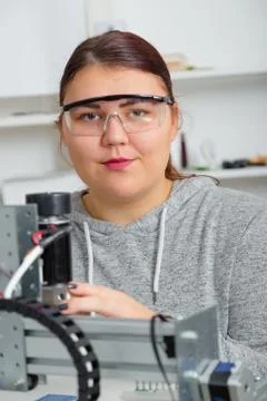 Female Apprentice working  on CNC machinery. Stock Photos