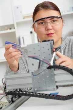 Female Apprentice working  on CNC machinery. Stock Photos