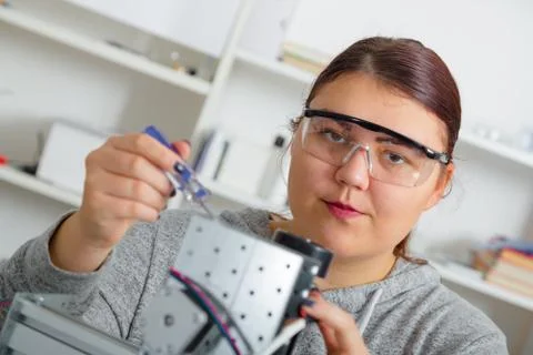 Female Apprentice working  on CNC machinery. Stock Photos