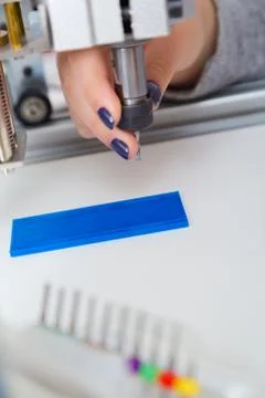 Female Apprentice working  on CNC machinery. Stock Photos