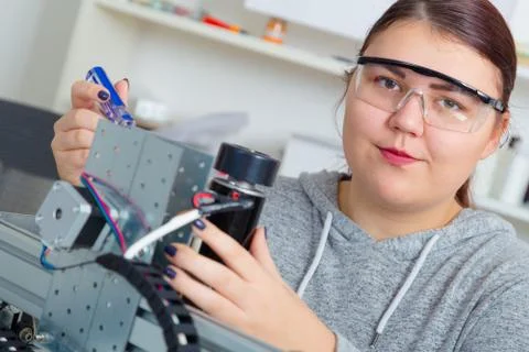 Female Apprentice working  on CNC machinery. Stock Photos