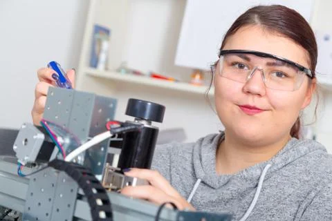 Female Apprentice working  on CNC machinery. Stock Photos