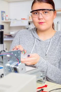 Female Apprentice working  on CNC machinery. Stock Photos