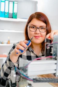 Female Apprentice working  on CNC machinery. Stock Photos