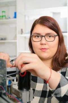 Female Apprentice working  on CNC machinery. Stock Photos