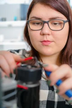 Female Apprentice working  on CNC machinery. Stock Photos