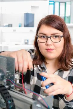 Female Apprentice working  on CNC machinery. Stock Photos