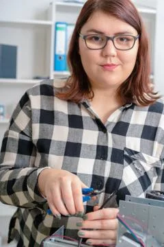 Female Apprentice working  on CNC machinery. Stock Photos