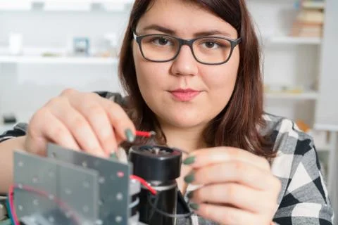 Female Apprentice working  on CNC machinery. Stock Photos