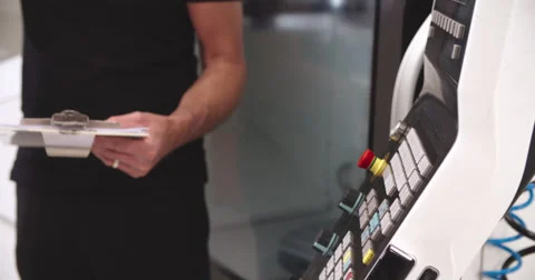 Female Apprentice Working With Engineer On CNC Machinery Video stock 56213564