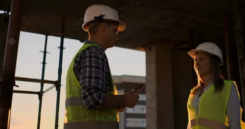 Female architect and construction worker shaking hands. Low angle view, copy Stock Footage 113049624