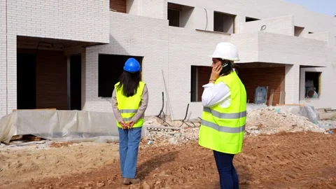 Female architect and engineer inspecting a construction site Stock Footage 334555725