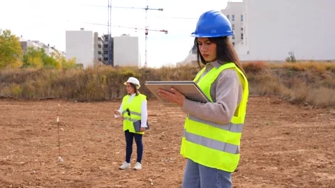 Female architect and engineer working on a construction site project Stock Footage 334578259