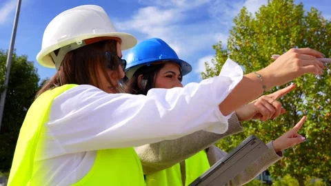 Female architect and engineer working with a tablet on a construction site Stock Footage 334578277