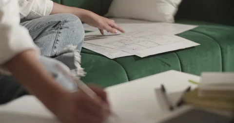 Female architect checking drafts and making notes Video stock 207673139