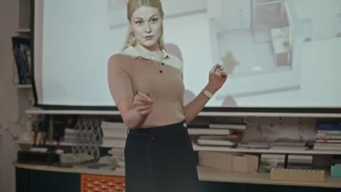 Female Architect Demonstrating Digital 3D Building Plan on Projector Stock Footage 327844851